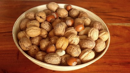 walnuts and hazelnuts in a wooden bowl