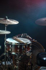 Fototapeta na wymiar musical instruments drum kit, flash of light, a beautiful light in the background with copy space