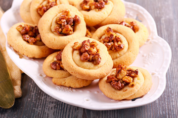 Obraz na płótnie Canvas Golden pecan twists, cookies with nuts