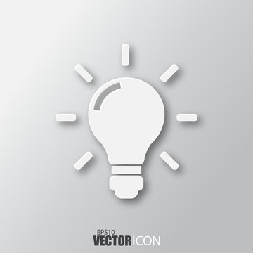 Light bulb icon in white style with shadow isolated on grey background.