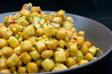 Close Up Of Italian Traditional Food Called Strufoli On Black Background.