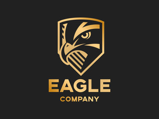 Head of the eagle on the shield - golden logo, mark, emblem on a dark background