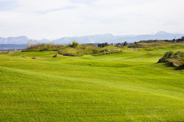 Golf course in Belek. Green grass on the field. Blue sky, sunny day