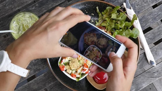 Close Up Of Woman Hands Photographing Vegan Food With Smartphone. 4K. 