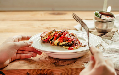 Warm vegetarian ratatouille made of eggplants, squash, tomatoes and onions. Served on a rustic...