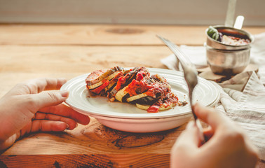 Warm vegetarian ratatouille made of eggplants, squash, tomatoes. Healthy vegetarian meal concept....
