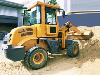 Yellow wheel loader at sand pit