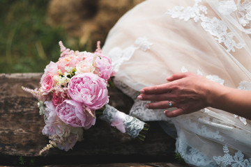 Bride's bouquet with hand with ring