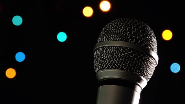 Audio microphone in karaoke bar with festive bokeh light background