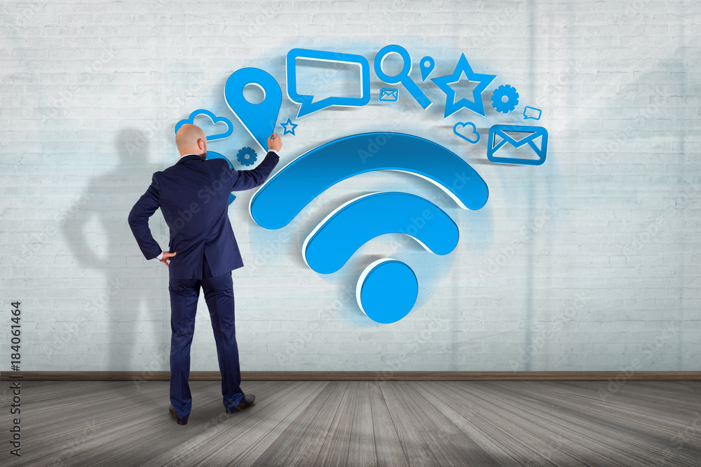 Poster Businessman in front of a wall with wifi symbol connection surrounded by multimedia and internet application logo - 3d rendering