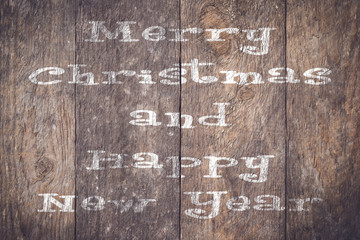 Christmas wishes on an old wooden plank.