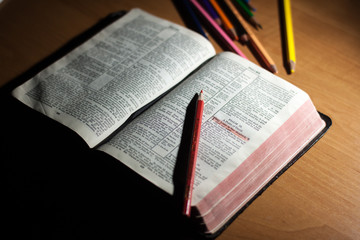 Bible and pencils