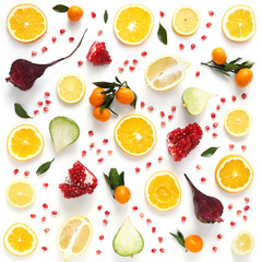 Creative flat layout of fruit, top view. Sliced orange, lemon, beet, tangerine, green leaves isolated on white background. Food wallpaper, composition pattern of fresh fruits and vegetables.	