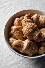 Fresh croissants on a white linen tablecloth.