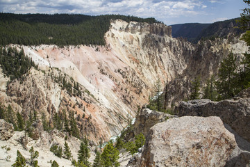 Fototapeta na wymiar Grand Canyon of the Yellowstone River with steep rock walls and a churning glacial fed river falling through it