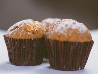 Fresh homemade delicious muffins with sugar powder