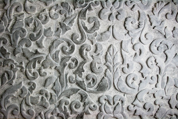 Stone carving emboss flower pattern,  craft work on black color of Granite stone. Concept image for interior design or architecture materials decoration.