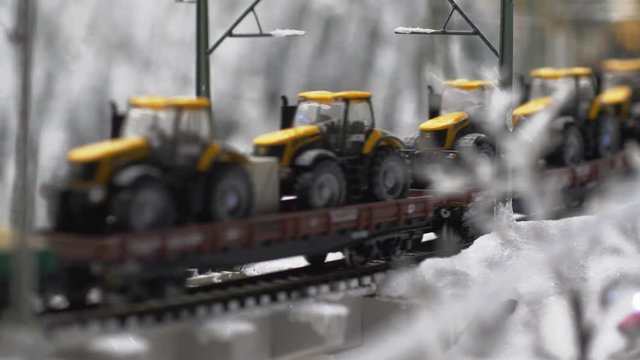 Platform with tractors and fuel tanks in winter in slow motion. 3840x2160