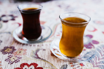 Two traditional Turkish teas with tulip mugs stand side by side on the table. Delicious and healthy drink.