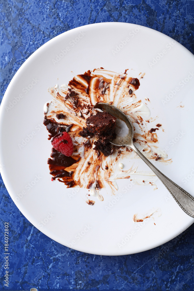 Wall mural empty plate after chocolate cake with cream