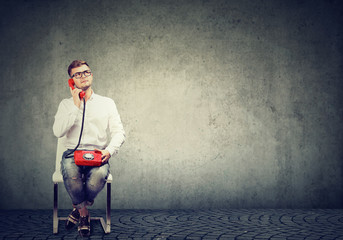 Dreaming man talking on retro phone