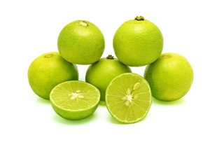 Five green limes (in pyramid stacking) and two splitted halves on white background. A kind of fruit used as an ingredient for cooking, especially in sour food. Scientific name - Citrus x aurantiifolia