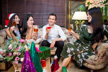 Many friends drinking wine in the party at night.