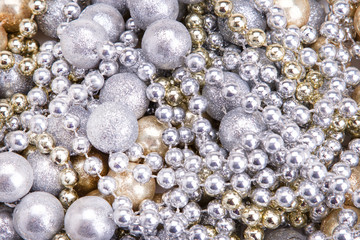 Background of gold and silver beads. Golden silver beads close-up.