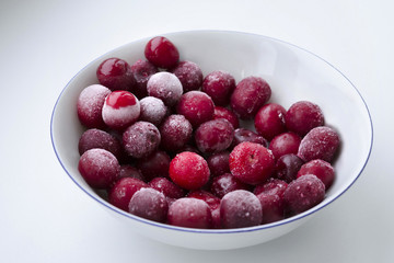 Frozen red cherries on a bright white background.