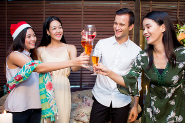 Many friends drinking wine in the party at night.