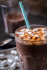 hot chocolate with small marshmallows in a glass beaker