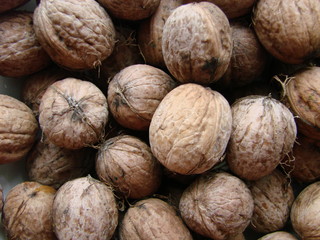Appetizing Walnut in the shell, eco-friendly, natural, close-up. Many walnuts. Nuts in a box. Texture nuts