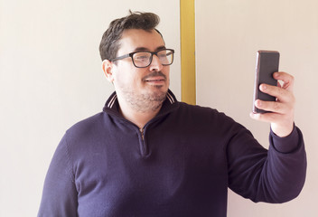     Handsome businessman taking a selfie with a mobile phone 
