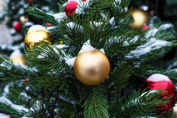 Beautiful Christmas toys on a Christmas tree with snow on city streets
