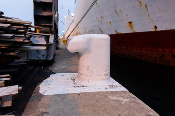Bollard with mooring ropes on the quay