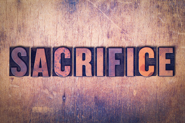 Sacrifice Theme Letterpress Word on Wood Background