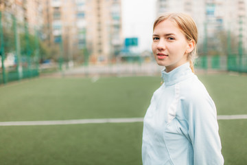 A young girl goes in for sports, portrait, handsome Girl in sportswear. The Girl works in the open, fresh air.