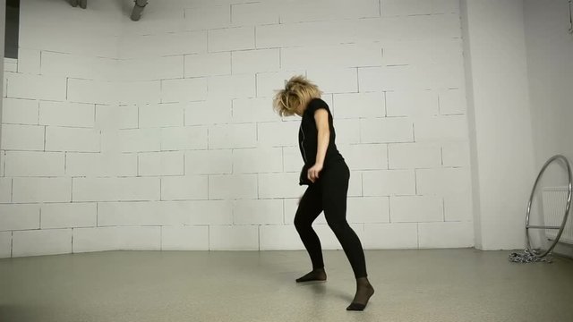 Asian woman dances in studio modern and street choreography Jazz-funk