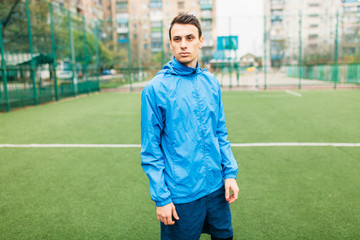 A young guy goes in for sports, portrait, handsome guy in sportswear. The guy works in the open, fresh air.