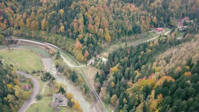Flying over river Prut and train railways in Carpathian Mountains, Ukraine
