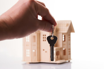 Real estate agent hand holds a house key