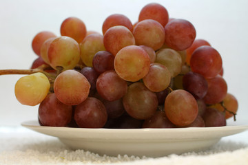 pink grapes on the plate