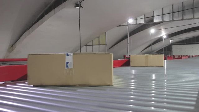 Boxes at Long Conveyor Rollers in Sorting Warehouse
