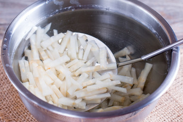 Slices of vegetables in ice water. Blanching