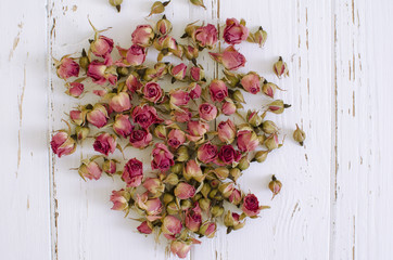  Dry roses on the wooden background