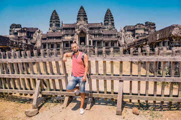 Man in the ruins of Angkor Wat. Backpacker traveling in Siem Reap, Cambodia.