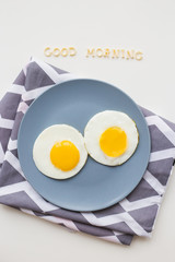 two eggs on a plate, the inscription Good Morning