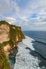 Fototapeta na wymiar Beautiful view of ocean rocky cliff near Uluwatu temple. Scenic landscape of fantastic view. Bali, Indonesia.