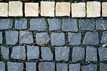 Old pavement floor. Black and white floor squared stones texture pattern.