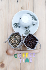 Bag of coffee beans and a cup of coffee on the table.